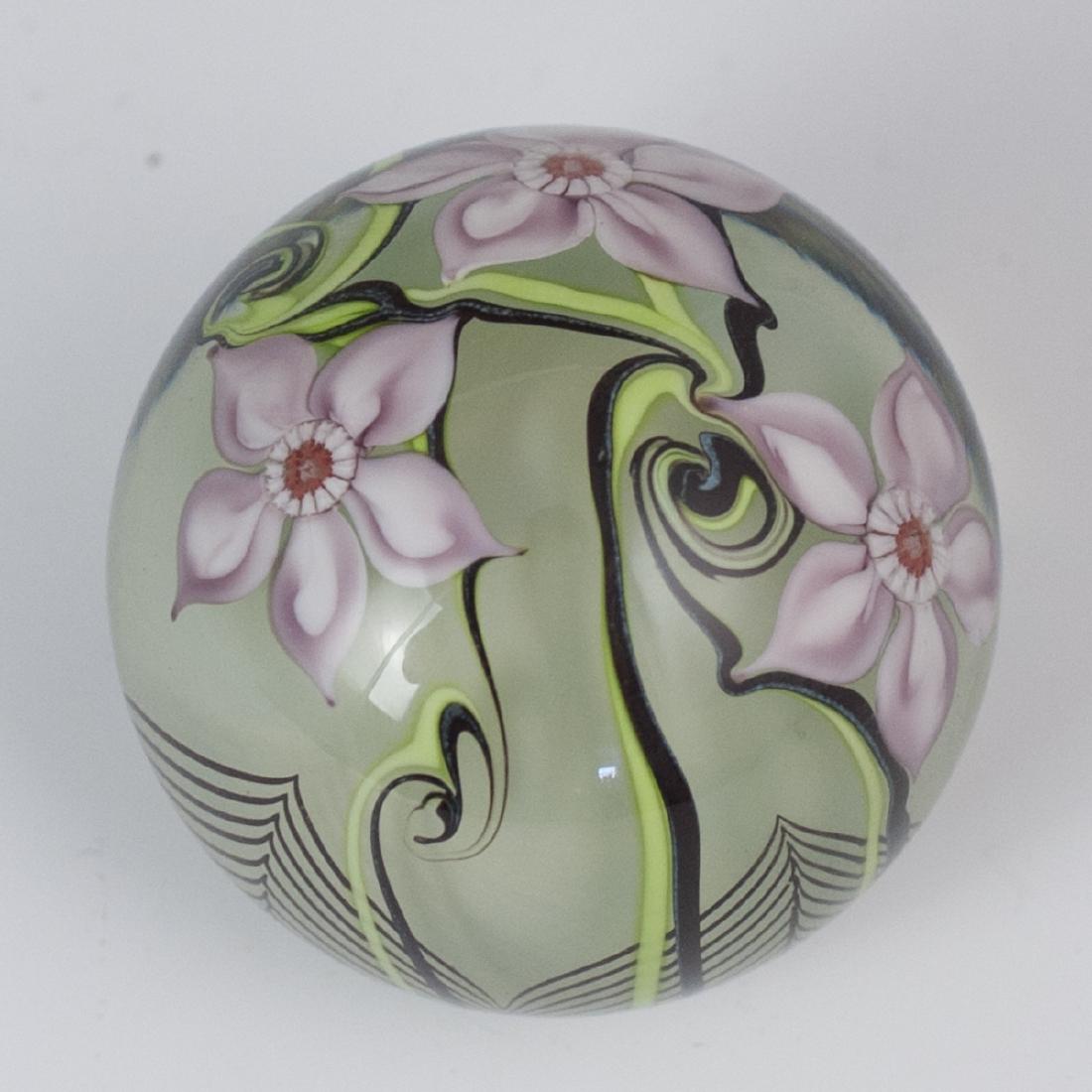 Orient & Flume Art Glass Paperweight: DESCRIPTION: An Orient & Flume, art glass paperweight. Features a globular form, decorated with interior floral motifs and pulled detailing along the bottom. Marked:"Orient & Flume 1978". CIRCA: Late