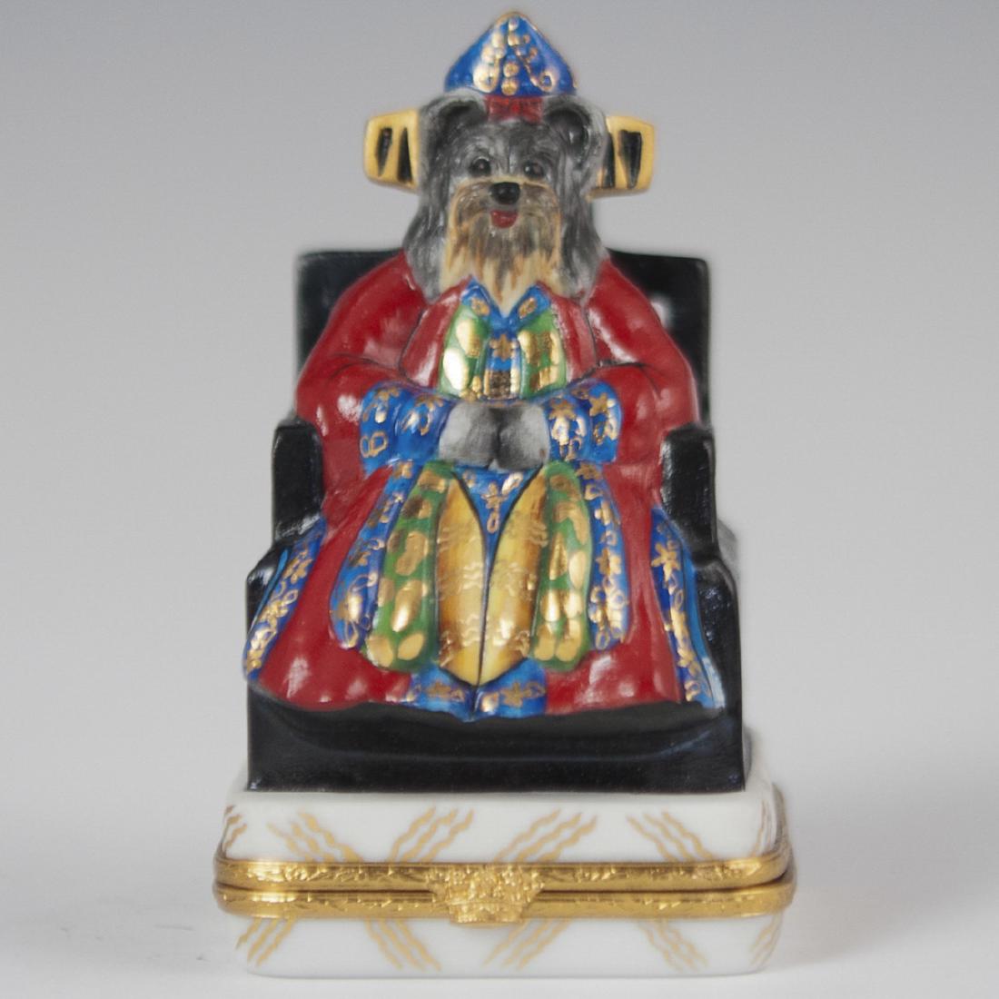 Artoria Limoges Limited Edition Porcelain Pillbox: DESCRIPTION: An Artoria Limoges limited edition porcelain pill box. Features an anthropomorphic terrier as a Chinese emperor seated in a throne. Finished with gilded trims, and a gilt metal lining wit