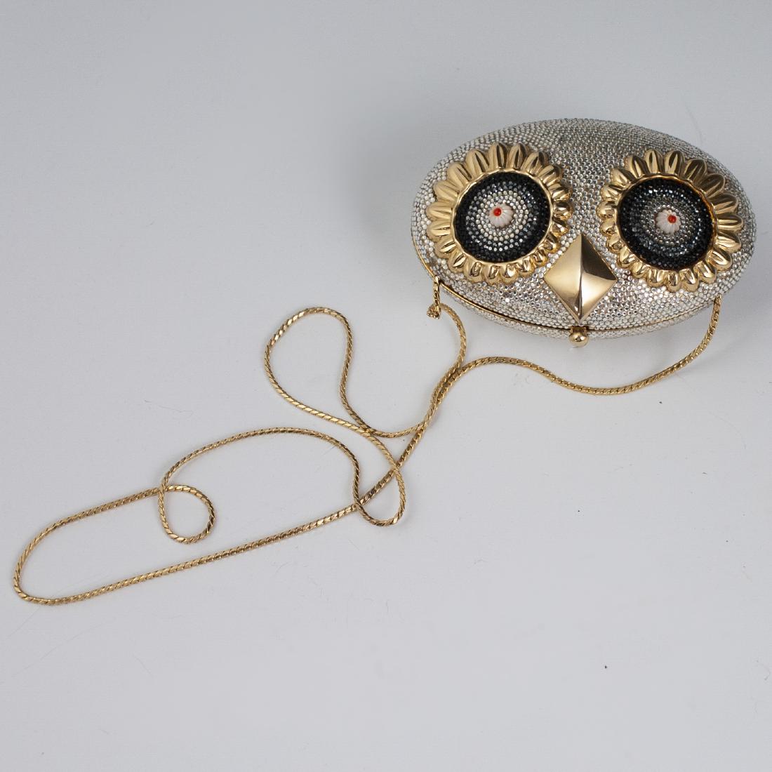 Judith Leiber Swarovski Crystal Minaudiere: DESCRIPTION: A Judith Leiber minaudiere bag. Features an owl head, ovoid design, embellished with faceted Swarovski crystals throughout. Fitted with a gilt metal chain strap and opens to reveal a gilt