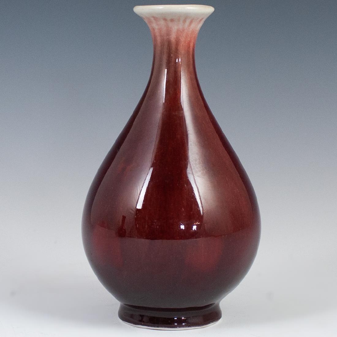Chinese Porcelain Yuhuchunping Flambe Vase: DESCRIPTION: A Chinese porcelain Yuhunchunping, "pear shaped" flambe vase. Embellished with a rich sang de boeuf crackle glaze with a beige tone along the rim. Not marked. CIRCA: Early-Mid 20th Ct. OR