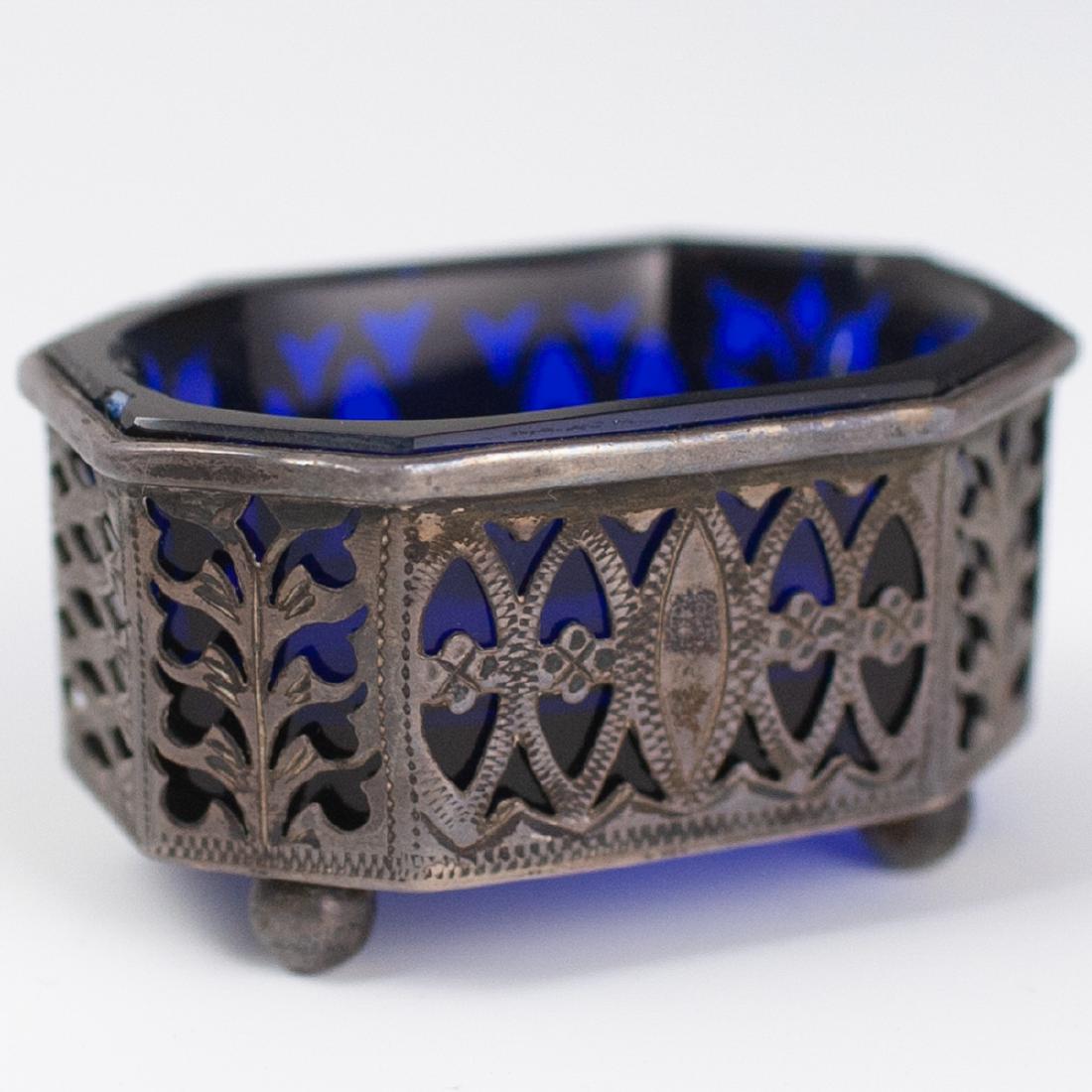 George Nathan & Ridley Hayes Sterling Salt Cellar: DESCRIPTION: An antique George Nathan & Ridley Hayes salt cellar. Features an octogonal form with a reticulated, floral motif body. Finished with a cobalt glass insert. Marked with George Nathan & Rid