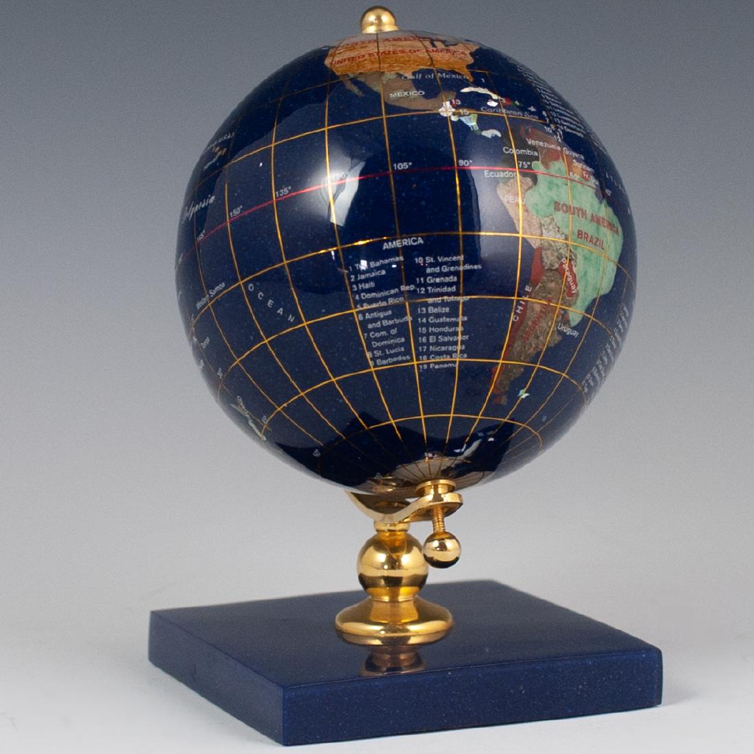 Semi-Precious Stone Globe: DESCRIPTION: A semi precious stone globe on a titled gilt metal axis. Designed with a lapis lazuli foundation, and inlaid semi-precious stone continents. CIRCA: Late 20th-21st Ct. DIMENSIONS: H:6.5" C