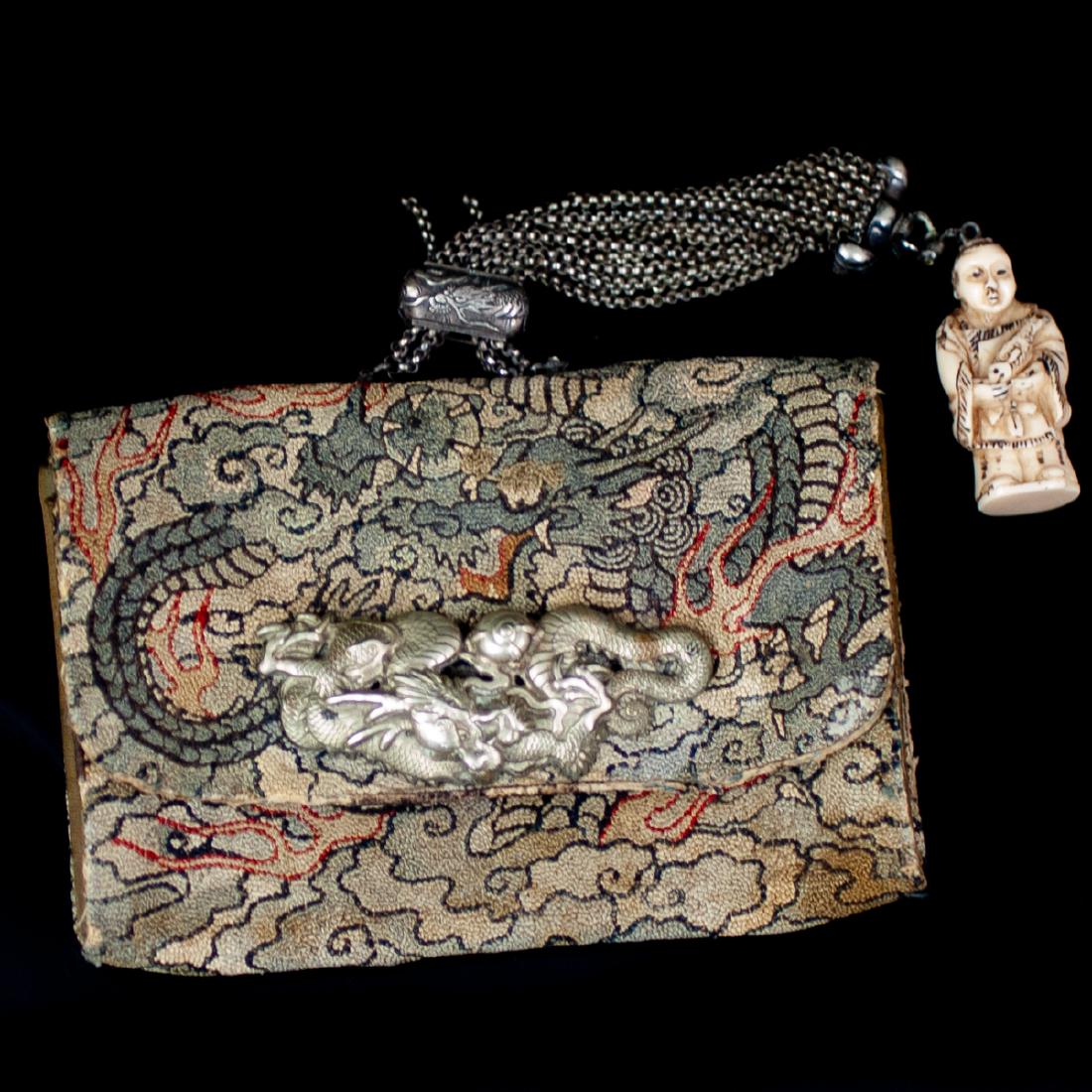 Japanese Silk Tobacco Pouch: DESCRIPTION: An antique Japanese, Edo Period, silk tobacco pouch, fitted with a silver, chained tassel with an engraved slide, fitted with a carved bone netsuke. The pouch features an overall embroide