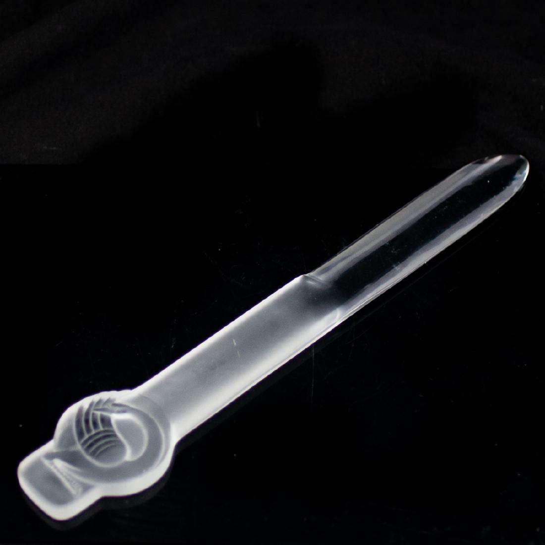Lalique Crystal Letter Opener: DESCRIPTION: A large Lalique crystal letter opener. Features a clear crystal blade, and a frosted crystal handle with a coiled swan motif. Marked:"Lalique France". CIRCA: Late 20th-21st Ct. ORIGIN: Fr