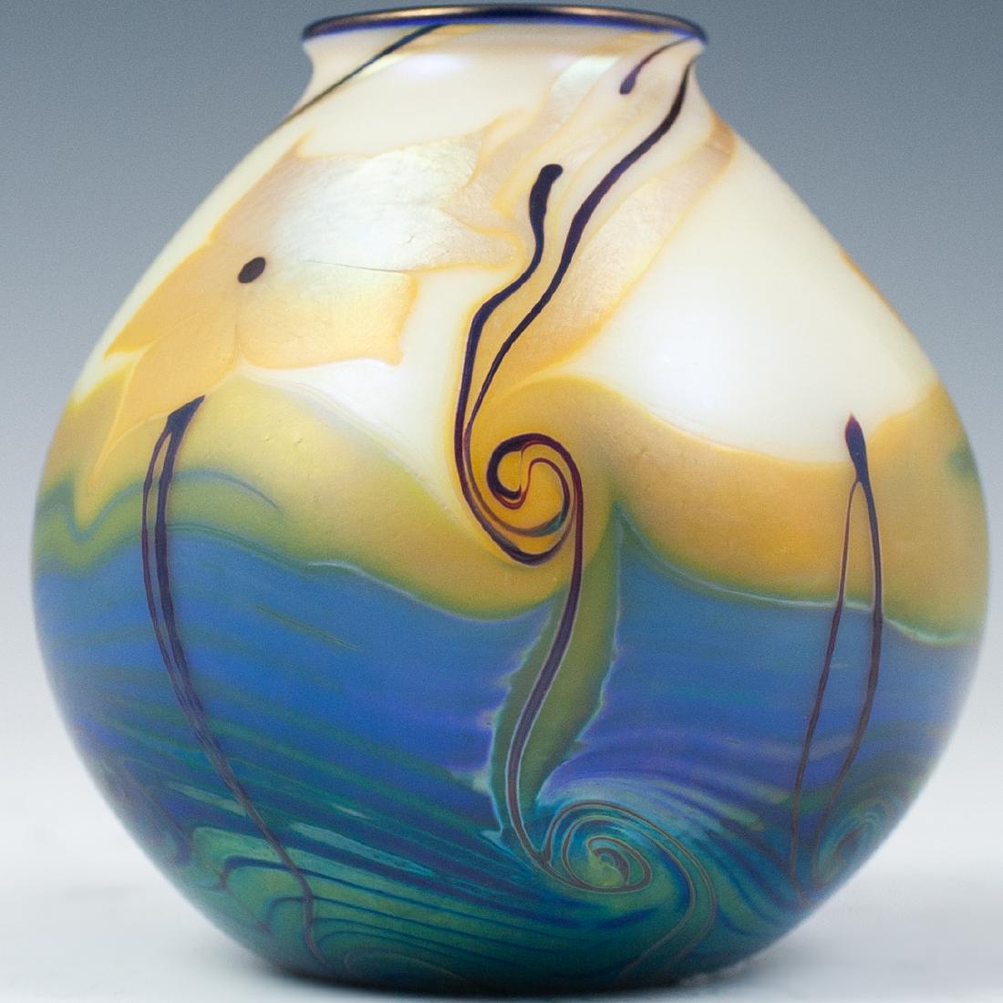 Orient & Flume Art Glass Vase: DESCRIPTION: An Orient & Flume art glass vase garnished with iridescent tone and an overall satin texture, embellished with leafy motifs and swirled accents. Marked "Orient & Flume 1977". CIRCA: 1977