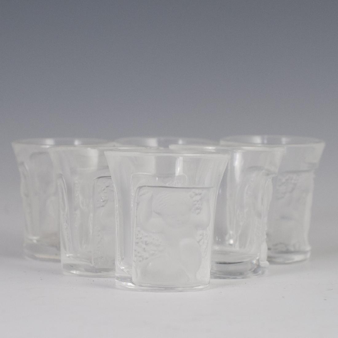 Lalique "Les Enfants" Crystal Cordials: DESCRIPTION: A set of 6 Lalique crystal "Les Enfants" patterned cordials. Features frosted crystal, embossed motifs of nude cherubs enveloped by grape clusters. Marked: "Lalique France". CIRCA: Late 2