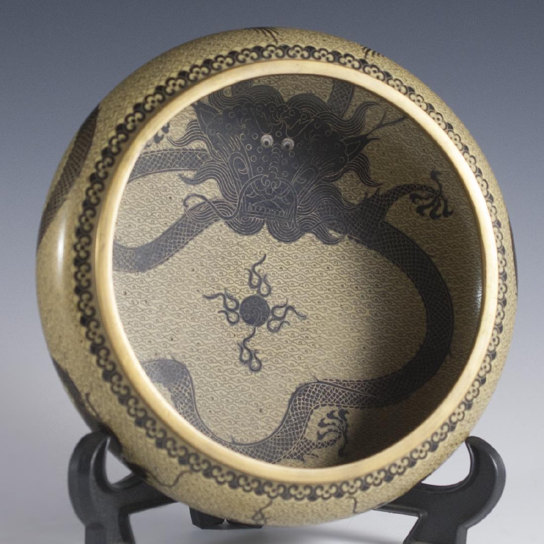 Signed Cloisonne Enameled Dragon Bowl: DESCRIPTION:Signed cloisonne dragon bowl featuring very intricate wired enameled dragons along the exterior of the bowl with a rich light brown base color. The interior features imperial five finger d