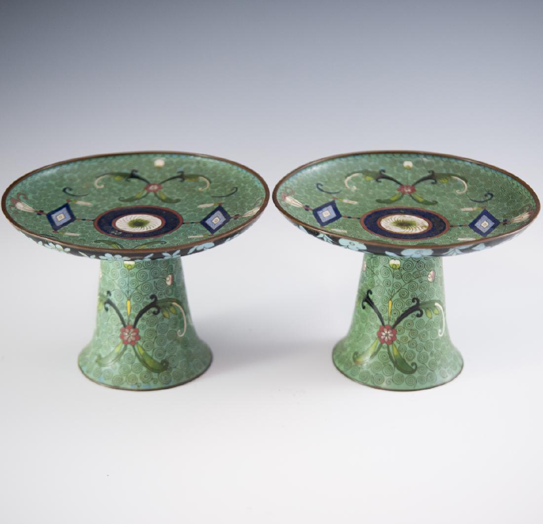 Antique Chinese Cloisonne Enameled Tazzas: DESCRIPTION: A pair of antique Chinese cloisonne enameled tazzas. Features a rich turquoise base hue with wired coiled patterns and enameled renderings of floral motifs and traditional patterns. Rests