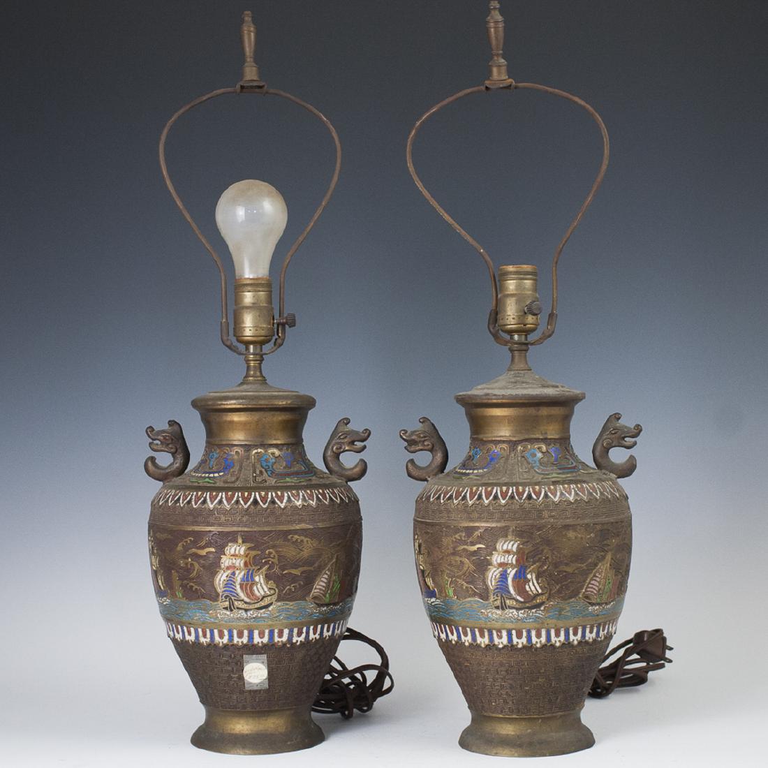Chinese Bronze Cloisonne Enameled Lamps: DESCRIPTION: A pair of Chinese bronze cloisonne enameled lamps. Embellished with enameled depictions of sail boats at rough seas backed by waved grooves. Finished with meander designs and mythical bea