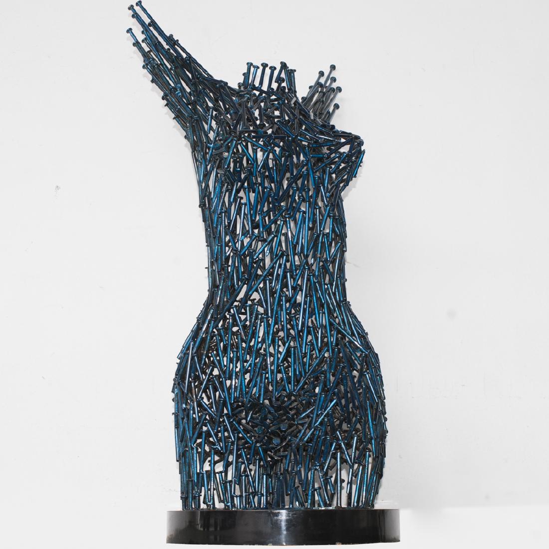 Niso Maman (American Israeli B.1957-): DESCRIPTION: A contemporary metal sculpture by Niso Maman. Features an abstract female nude body composed of nails, embellished with a metallic blue polychrome. Signed:"Niso TM". Fitted to a rotating