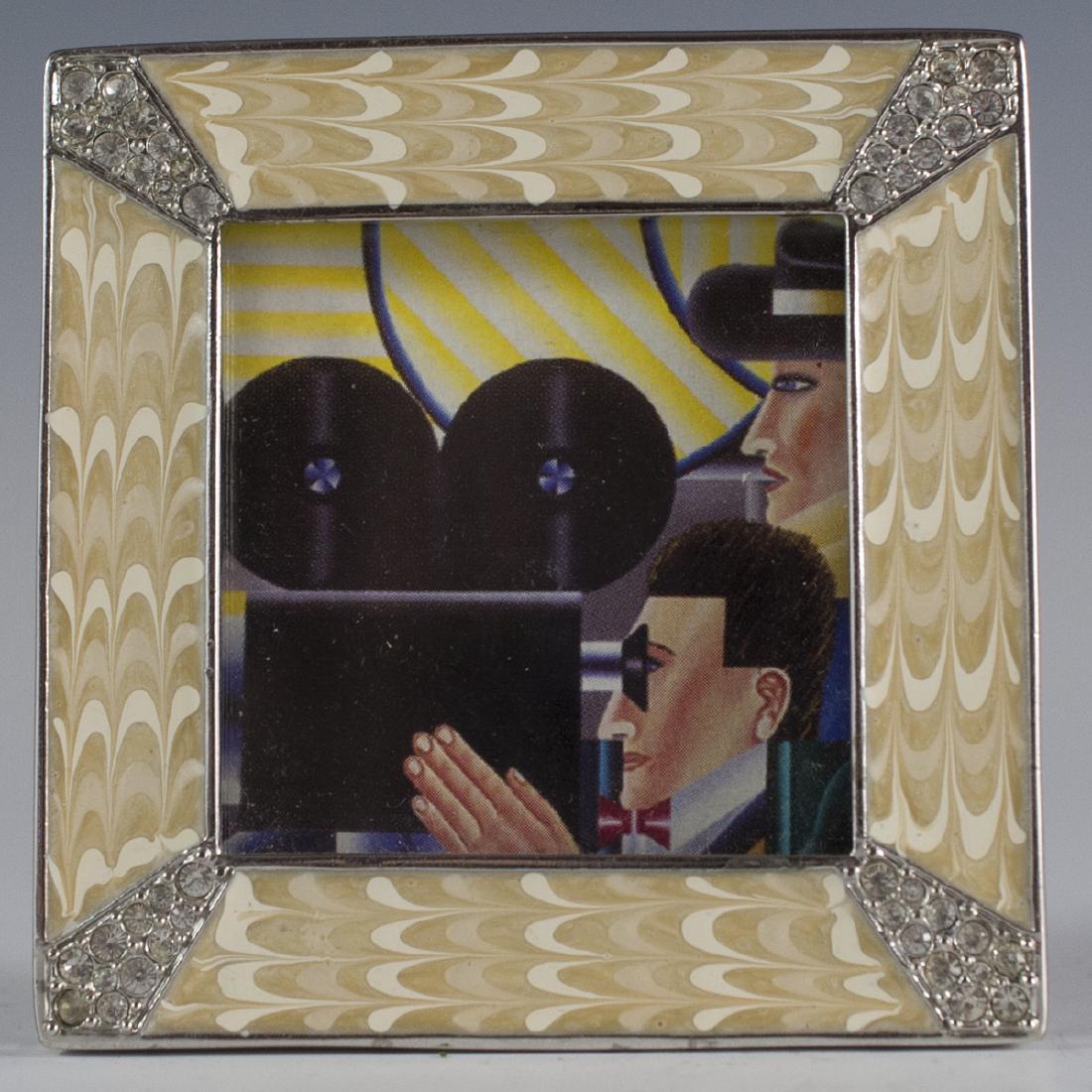 Jay Strongwater Picture Frame: DESCRIPTION:Jay Strongwater picture frame featuring swirled fishnet creme enamel designs. Embellished with Swarovski crystals at each corner and marked:"Jay Strongwater". CIRCA:20th Ct. ORIGIN:USA DIM