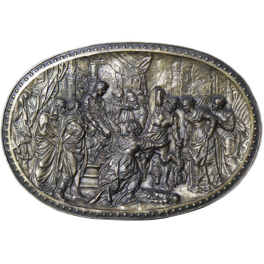 Antique Continental Brass Relief Plaque: DESCRIPTION: A Continental brass relief plaque. Features a repousse scene of a Biblical scene with a Roman emperor seated in a throne backed by figures pointing towards a nude figure, being protected 
