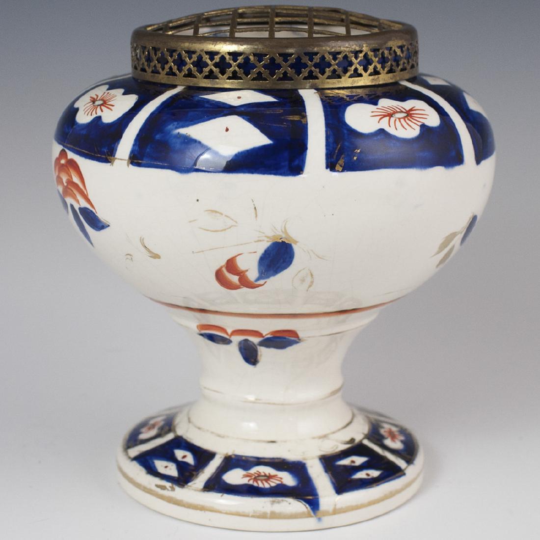 Arthur Wood "Gaudy Welsh" Porcelain Vase: DESCRIPTION: An antique Arthur Wood "Gaudy Welsh" Imari patterned porcelain vase. Embellished with rust, cobalt, and gilded accents. Finished with an open work gridded lid composed of brass. Marked wi