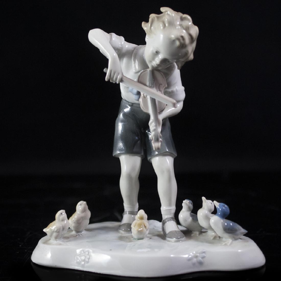 Metzler & Ortloff Porcelain Figurine: DESCRIPTION:Porcelain figurine by Metzler & Ortloff. Features a handpainted young boy playing the violin while birds and ducks gaze up at him. Marked on bottom: "MO Germany" CIRCA:20th Ct. ORIGIN:Germ