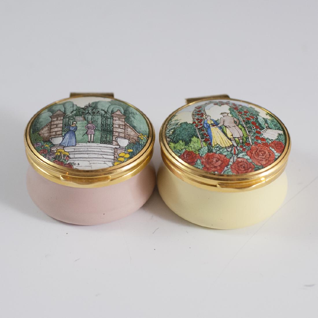 Franklin Mint "English Enamels" Trinket Boxes: DESCRIPTION: A pair of Franklin Mint "English Enamels" trinket boxes. Features rose and yellow base hues garnished along the lids with English enameled scenes. Marked along undersides:"The Poetry of L