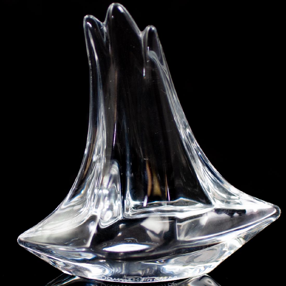 Daum Sailboat Crystal Figurine: DESCRIPTION: Daum crystal sailboat figurine/paperweight in a fluid design. Engraved "Daum France" along the base. CIRCA: Late 20th Century ORIGIN: France DIMENSIONS: H: 4 1/4" L: 4 1/8" W: 1 1/2" COND