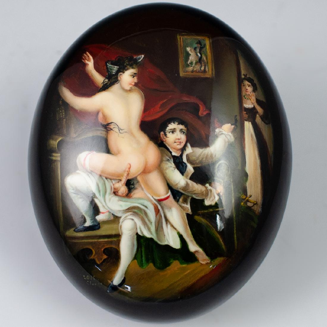 Russian Erotic Lacquered Oval Box: DESCRIPTION: Russian lacquered papier mache boxes. The box in an overall black hue in form of an oval shape, decorated with multiple hand painted Edwardian erotic scenes on the lid. Opens revealing a 