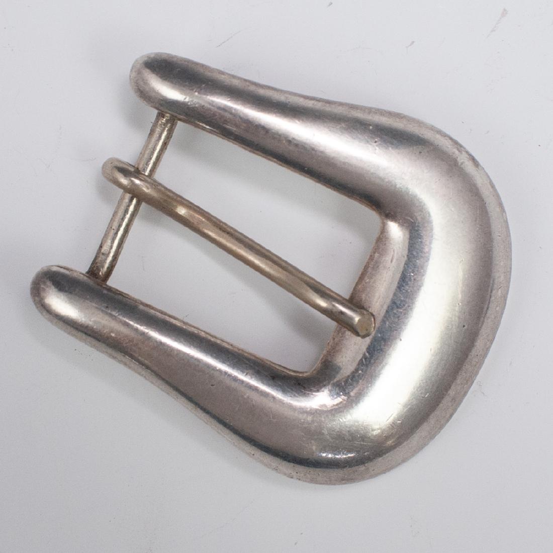 Sterling J.W Cooper Belt Buckle: DESCRIPTION: A sterling silver belt buckle by maker J.W Cooper, marked "Sterling Made in U.S.A" and "J.W Cooper" CIRCA: 20th Ct. ORIGIN: USA DIMENSIONS: H: 2" L: 1 5/8" Weight: 22 grams CONDITION: Gre