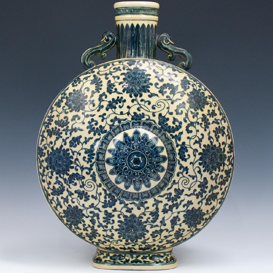Chinese Blue and White Moon-flask, Bao Yueping: DESCRIPTION: Chinese Blue and White Moon-flask, Bao Yueping. Decorated with floral motif throughout. Marked with a blue and white stamp on the bottom. CIRCA: 19th ORIGIN: China DIMENSIONS: H:20" W:15"