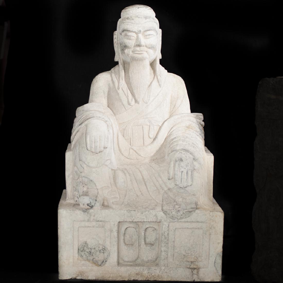 Chinese Carved Stone Emperor: DESCRIPTION: A Chinese carved stone emperor. Features a regal emperor, seated atop a throne, with his hands on his lap. The front, bottom of the base is centered by two carved shoes flanked by symmetr