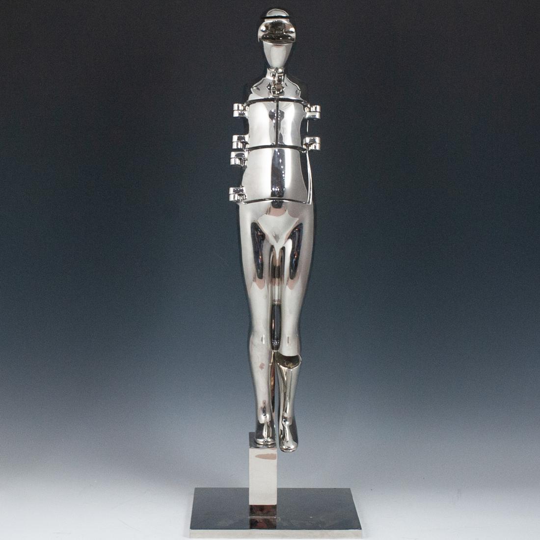 Ernest Trova (American.1927-2009) Sculpture: DESCRIPTION: A sculpture by American surrealist artist Ernest Trova features a chrome plated bronze figure the "falling man" or "folding man" crafted with mechanical appendages. The torso, leg and fac