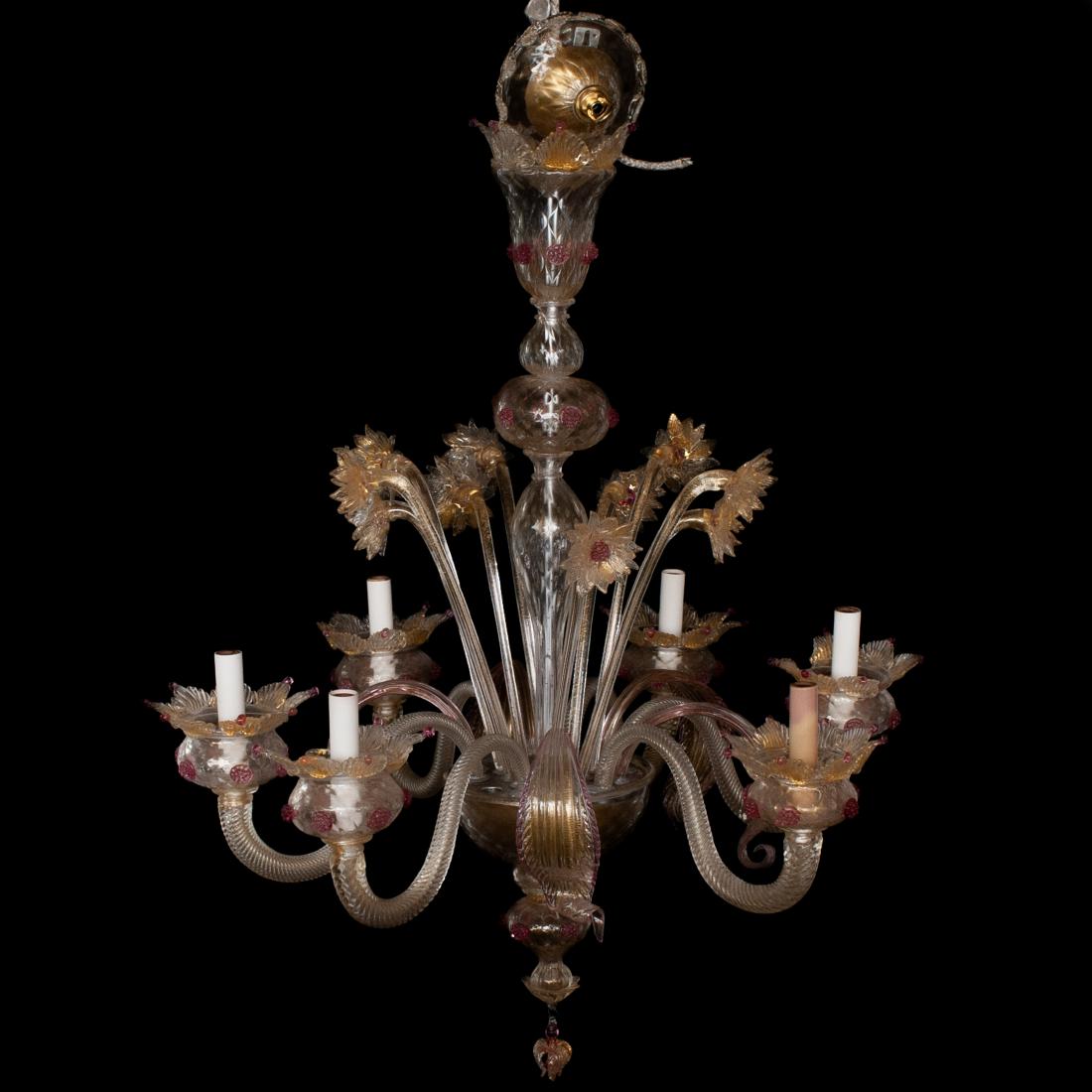 Murano Glass Floral Chandelier: DESCRIPTION: A chandelier composed of clear and colored murano glass, features a clear stem leading to a center bowl decorated by arching stemmed flowers with pink hues, embellished furthermore by six