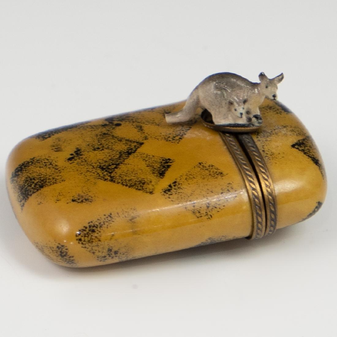Limoges Porcelain Kangaroo Pill Box: DESCRIPTION: Limoges porcelain pill box painted in overall yellow & black bse hues, completed with a kangaroo and cub motif on the clasp in naturalistic style. Marked along the interior "Limoges Franc