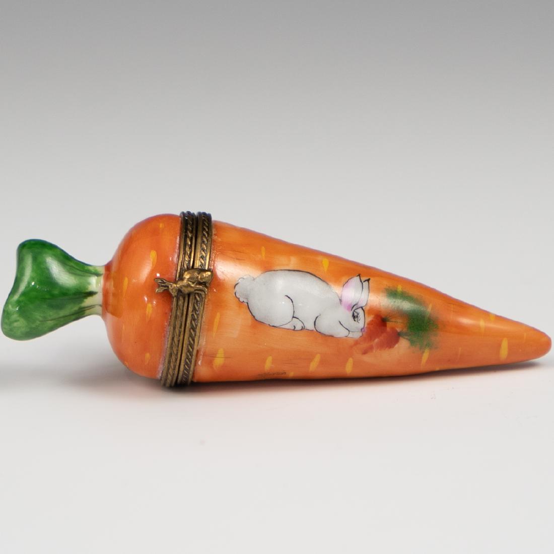 Limoges Porcelain Carrot Pill Box: DESCRIPTION: Limoges porcelain pill box in an overall carrot motif, embellished along the front with hand painted rabbit renditions, finished with a brass collar and rabbit motif clasp. Marked along t