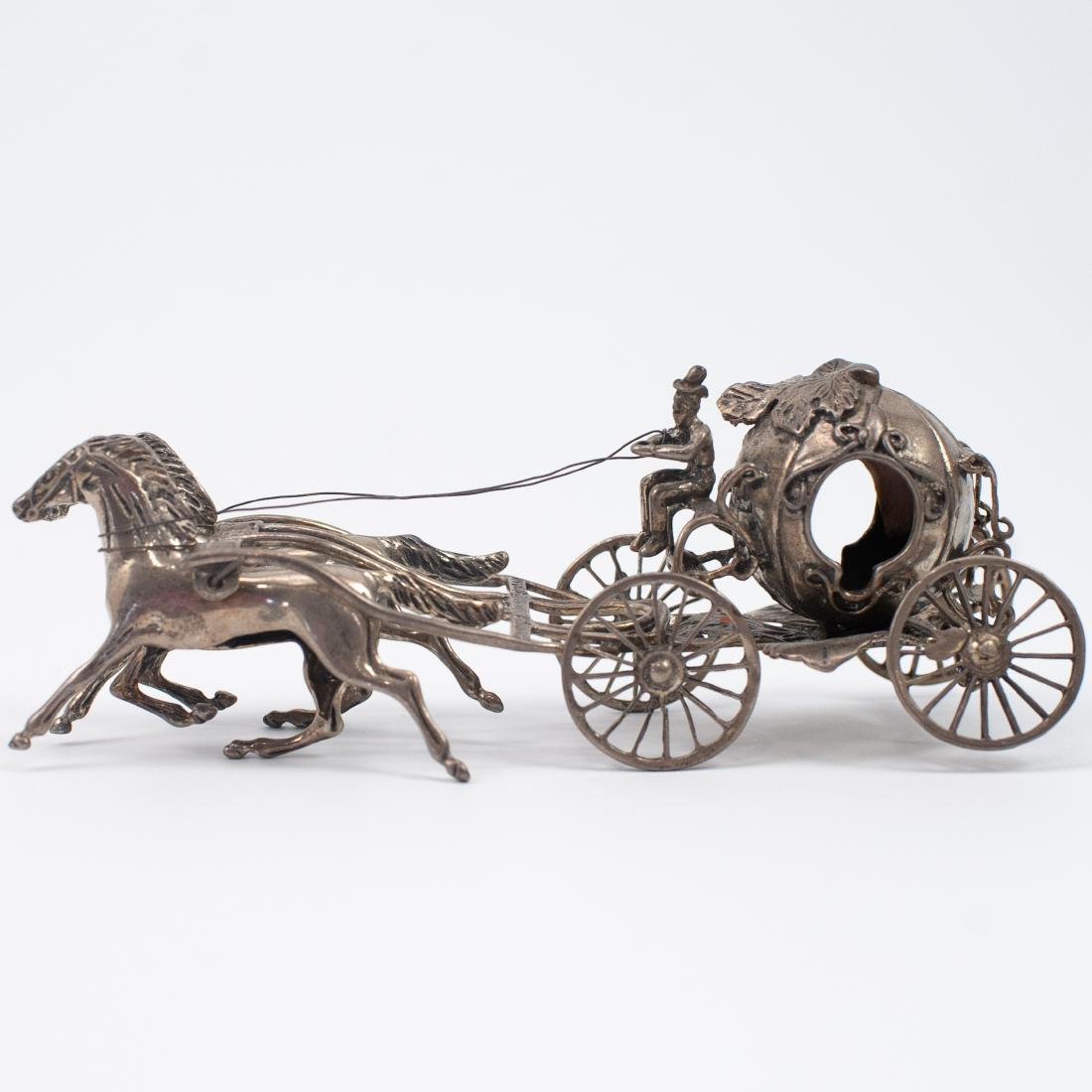 Sterling Silver Charriot Figurine: DESCRIPTION: A sterling silver figurine depicting a charriot led by two horses, signed along the bottom illegibly. CIRCA: 20th Ct. DIMENSIONS: H: 2 1/4" L: 6" Total Weight: 144 grams CONDITION: Great