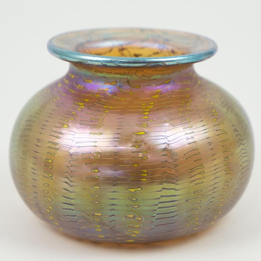 Loetz Style Iridescent Glass Vase: DESCRIPTION: A Loetz style iridescent glass vase. Features a globular body with a tapering rim and everted rim. Finished with yellow toned stripes. Not signed. CIRCA: Early-Mid 20th Ct. DIMENSIONS: H: