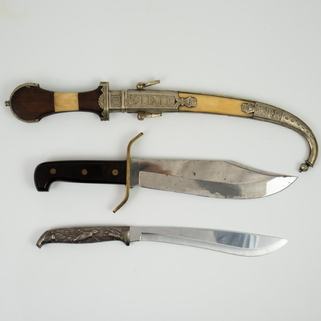 Antique & Vintage Daggers: DESCRIPTION: A set of three antique and vintage knives and daggers composed of the following: - 1 antique Moroccan jambiya dagger featuring a wooden handle and a bone and engraved metal scabbard with