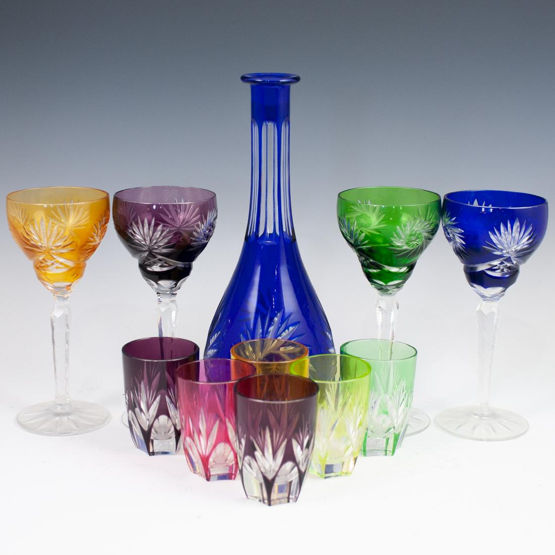 (11 Pc) Bohemian Crystal Liquor Set: DESCRIPTION: A liquor set of Bohemian crystal, features four wine glasses, six liquor glasses and 1 decanter. Each is embellished with crystal cuts in a variation of multicolored hues. CIRCA: Early-Mi