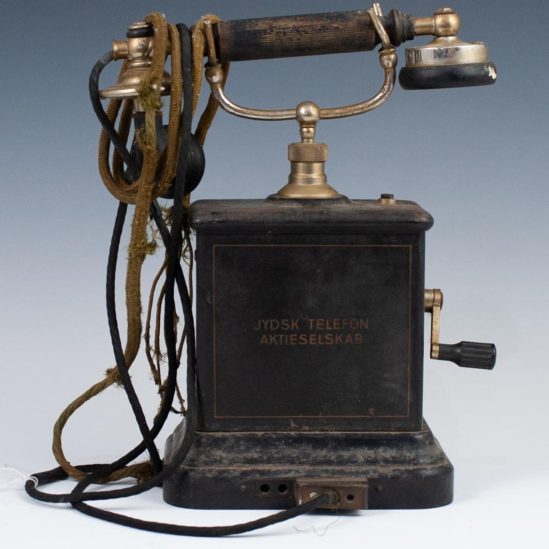 Antique Danish Jydsk Aktieselskab Telephone: DESCRIPTION: An antique Danish Jydsk Aktieselskab hand crank telephone. CIRCA: Late 19th-Early 20th Ct. ORIGIN: Denmark DIMENSIONS: H:12.5" L:7" CONDITION: Fair age appropriate condition. Some rust, u
