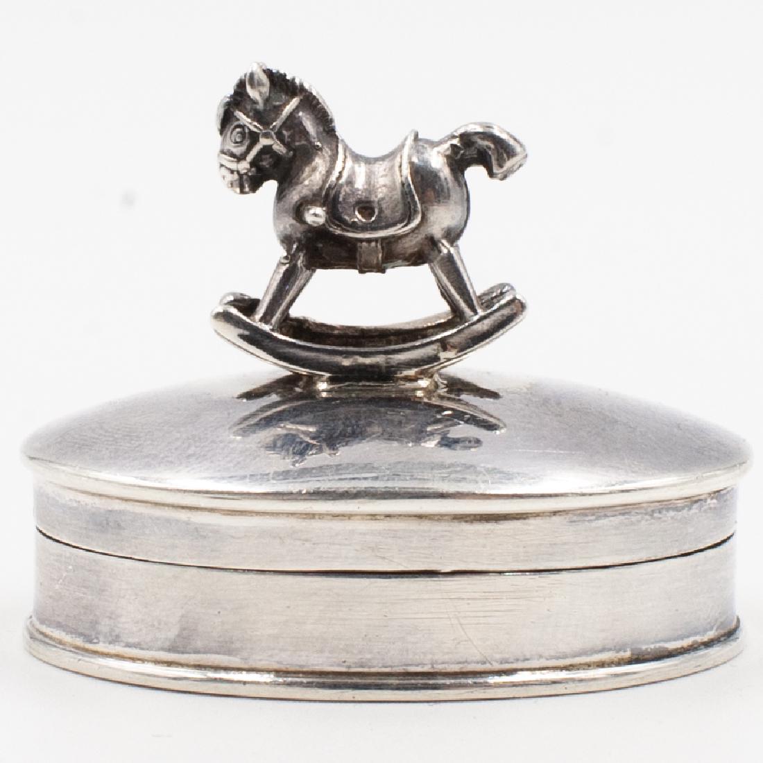 Sterling "Rocking Horse" Pill Box: DESCRIPTION: A sterling silver pill box features in an overall oval form topped with a horse motif finial, marked along the back "Lvrattos" and ".925" Total Weight: 18 Grams CIRCA: 20th Cent. ORIGIN: 