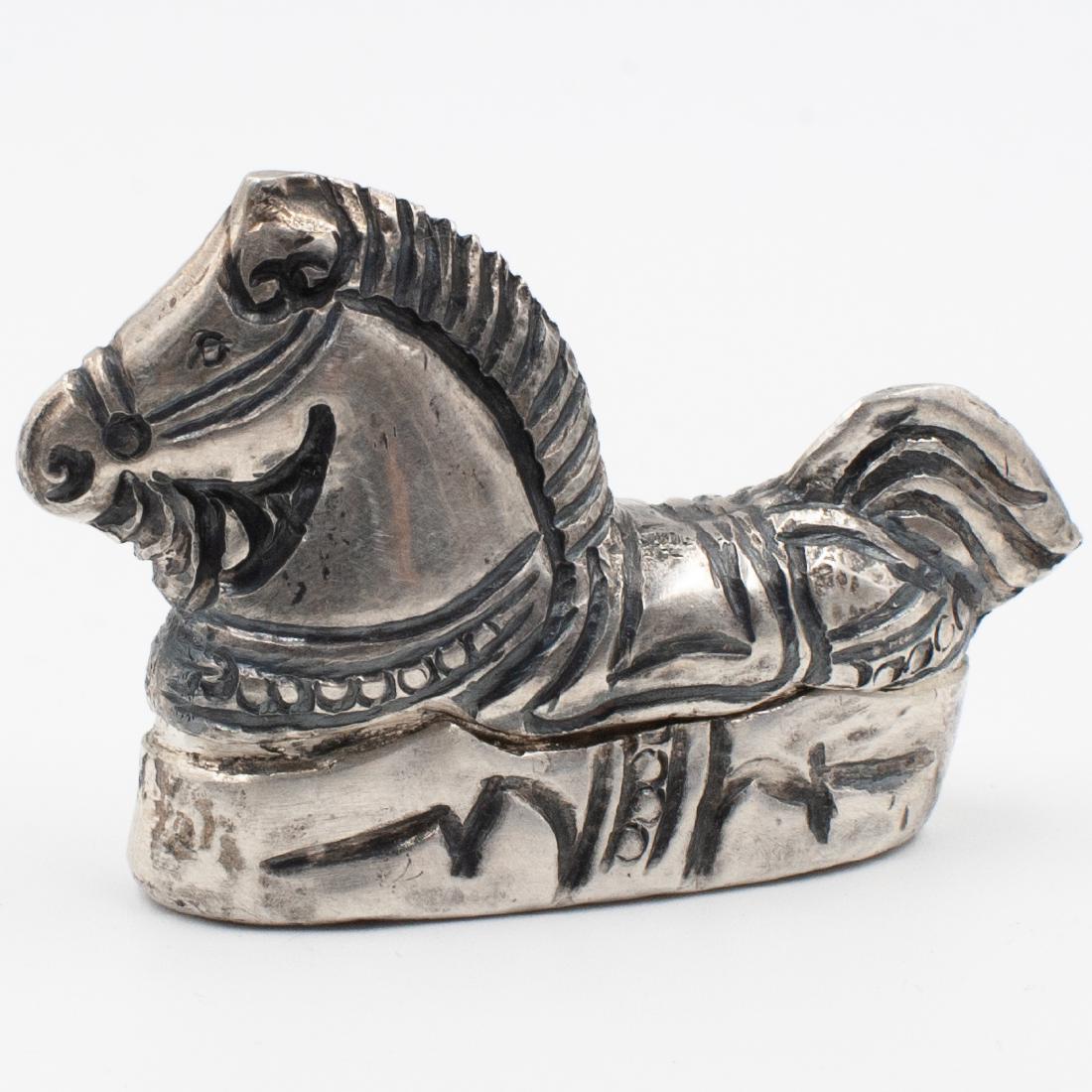 Equestrian Sterling Pill Box: DESCRIPTION: A sterling silver pill box channeled in an overall horse motif, marked illegibly along the side of the rim. Total Weight: 25 grams CIRCA: Early 20th Cent. ORIGIN: DIMENSIONS: H: 1 1/2" L: