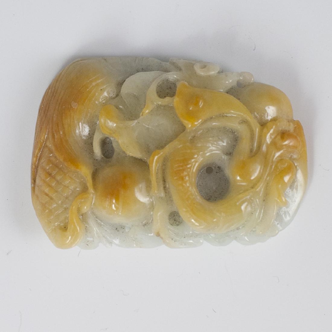 Chinese Carved Jade Medallion: DESCRIPTION: A Chinese carved jade medallion, carved along the front and the verso. The front is embellished with a soaring dragon design with yellow tones. CIRCA: 20th Ct. ORIGIN: China DIMENSIONS: H