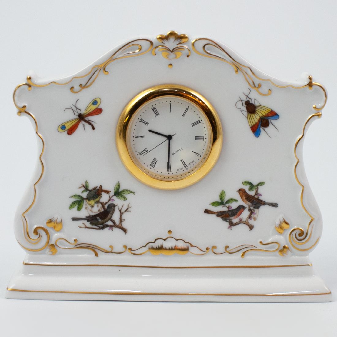 Herend Rothschild Bird Mantle Clock: DESCRIPTION: A Herend Hand-Painted Porcelain Rothschild Bird Clock. Clock in Roman Numerals by 'Movt Japan'. Marked on the underside: "Herend Hungary Handpainted" in blue. CIRCA: 20th Century ORIGIN: 