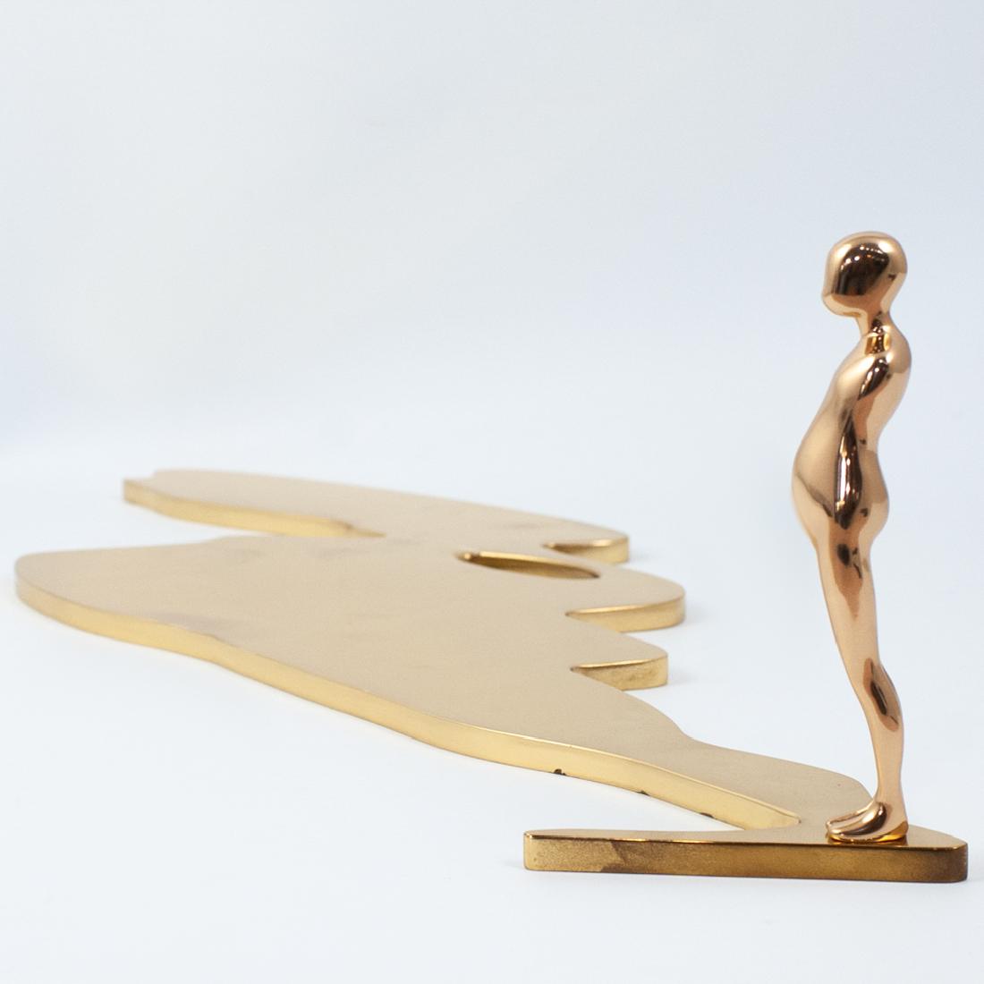 Ernest Trova (American.1927-2009) Figure With Shadow: DESCRIPTION: A sculpture by surrealist artist Ernest Trova composed of polished bronze depicts a study man with casted shadow behind the figure. Marked along the bottom Edition "79/99" dated 1987 with