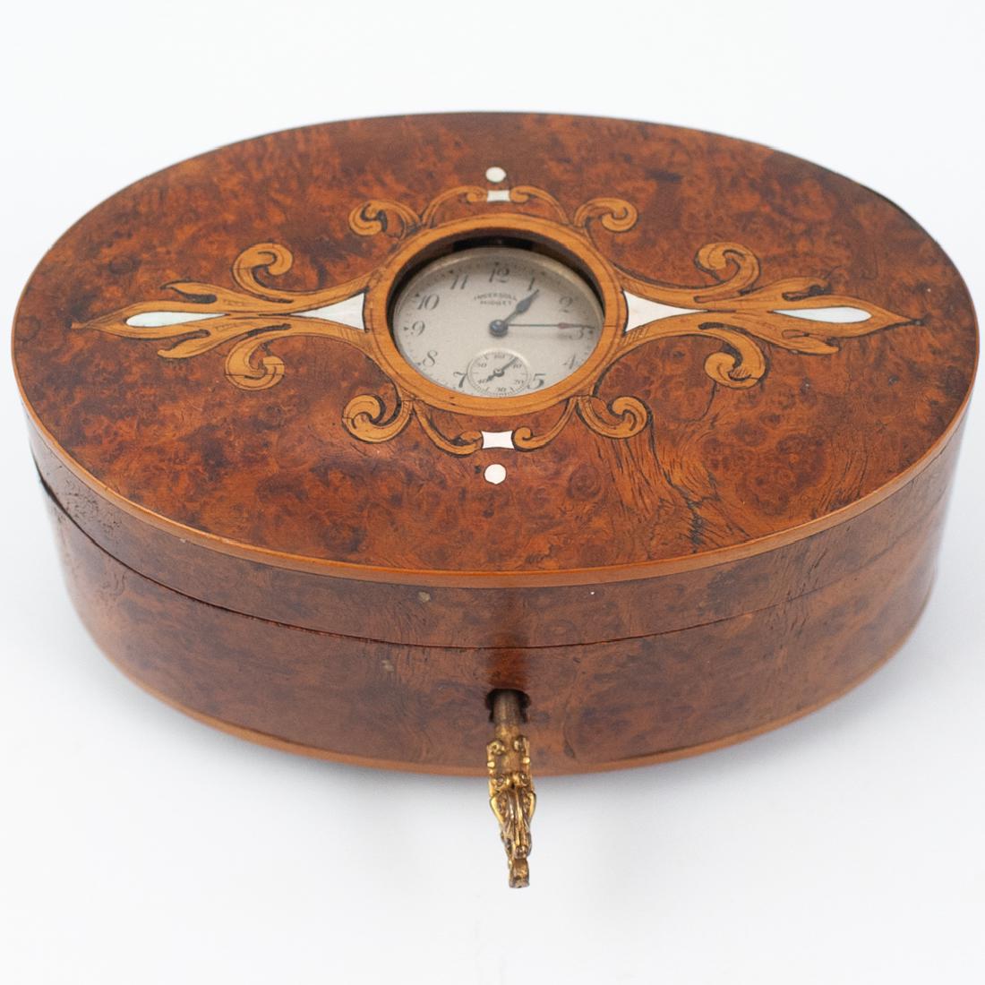 Vintage Burlwood and Mother of Pearl Inlaid Music Box: DESCRIPTION: Vintage Burlwood and Mother of Pearl Inlaid Music Box with Ingersoll Midget Clock, clock appears not be running, music box is in working order. Comes with original key CIRCA: Mid 20th Cen