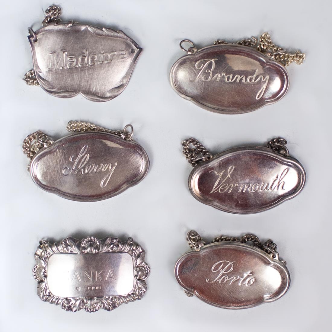 (6 Pc) Victorian Silver Plated Engraved Wine Plaques: DESCRIPTION: Lot of 6 Victorian silver plated liquor and wine labels. Features 'Porto', 'Vermouth', 'Madeira', 'Brandy', Sherry', 'Sanka'. Some are marked: "Made in Portugal" CIRCA: 20th Century ORIGI