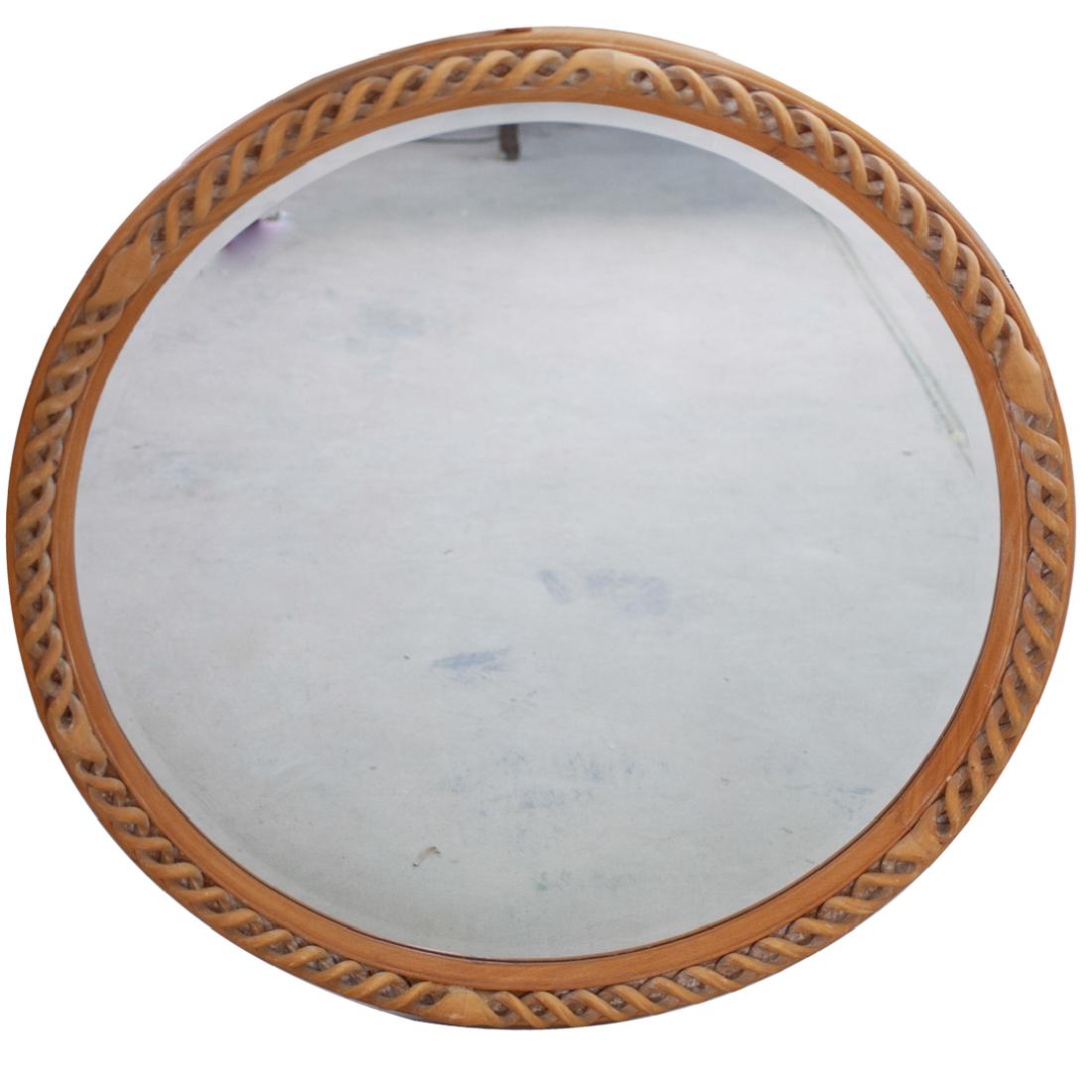 Italian Carved Wood Mirror: DESCRIPTION: An Italian carved wood oval wall mirror. Features intricately carved spiral wood design surrounded a mirror plate. Reverse has a label: "Made in Italy" CIRCA: 20th Century ORIGIN: Italy D