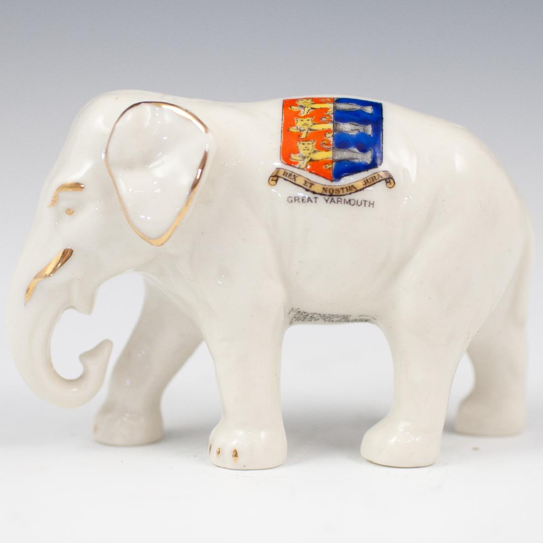 Shelley Crested Ware Elephant: DESCRIPTION: A "Shelley" crested ware elephant figurine. Features white porcelain elephant with crest "Rex et Nostra Jura" on side. Marked on the underside: "Shelley China 363, Manufactured for Palmer