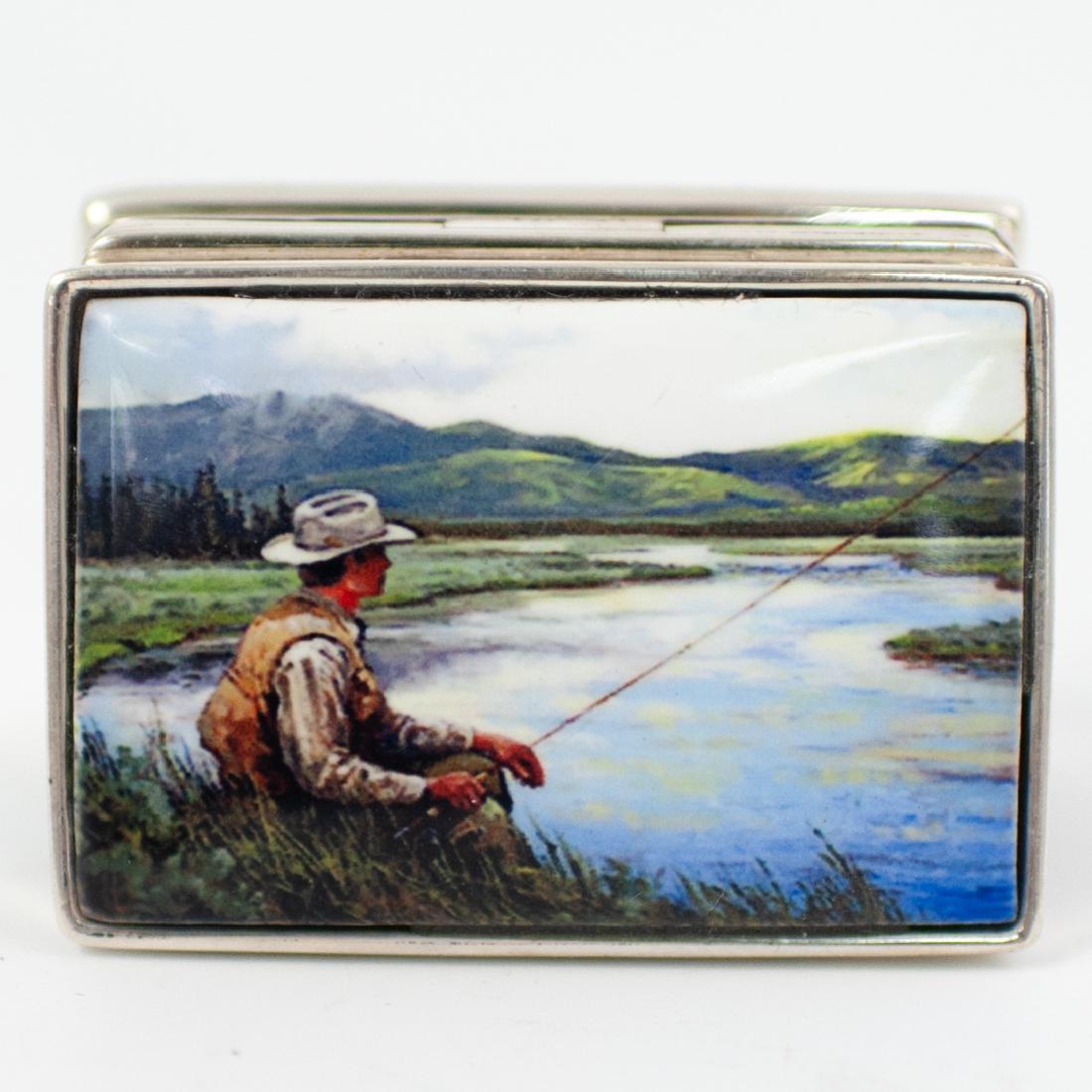 Sterling Silver Fishing Pill Box: DESCRIPTION: A Sterling silver pill box garnished along the lid with a fishing scene. Marked along the interior ".925". Total Weight: 42 grams CIRCA: Mid 20th Cent. ORIGIN: USA DIMENSIONS: W: 2" L: 1.