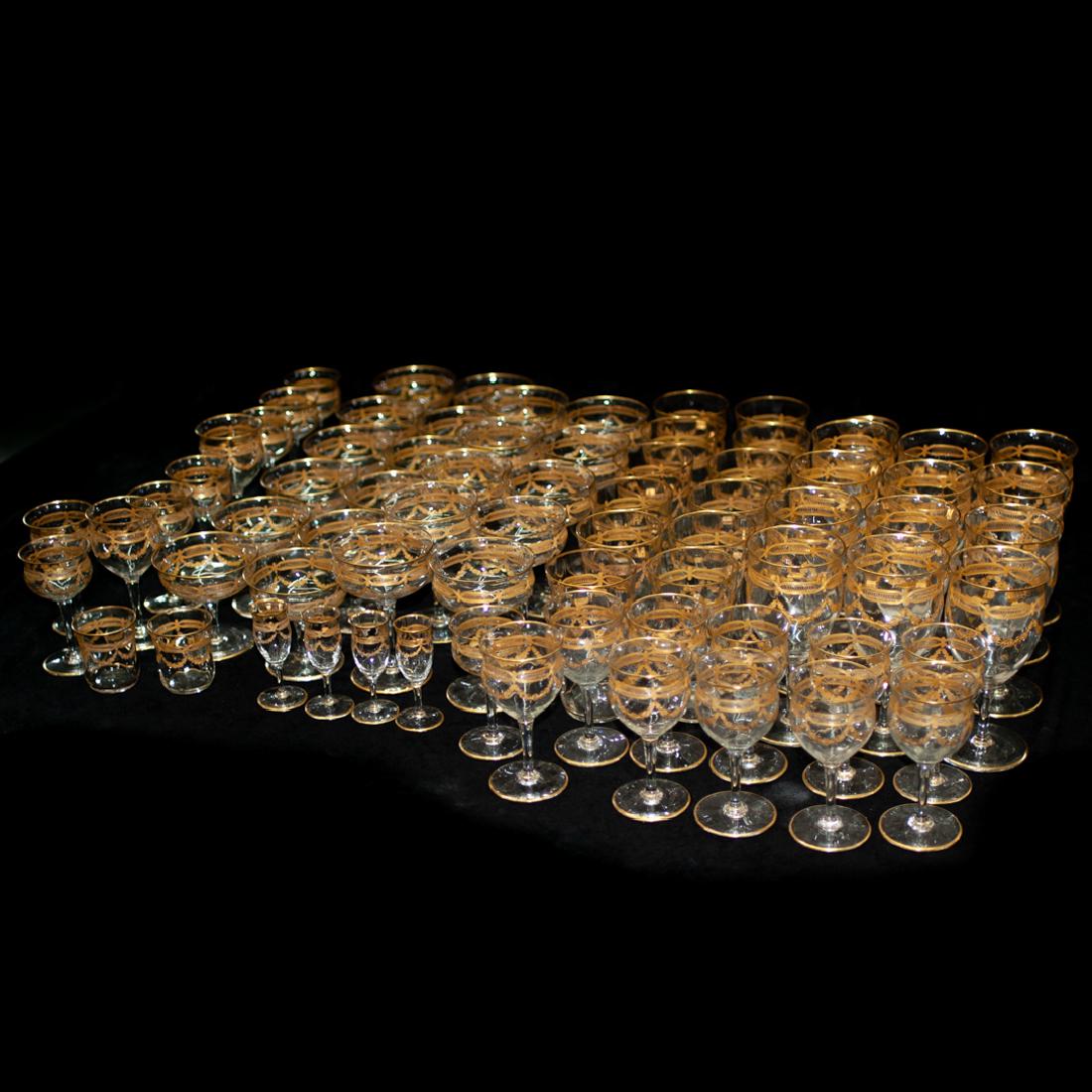 (89 Pc) Crystal and Gilt Decorated Glassware: DESCRIPTION: A 89-piece crystal and gilt decorated glassware. Each with painted gilt decorated floral and classical garland motifs with gilded rim and base. Unmarked. Comprising: 12 Wine glasses, H. 6
