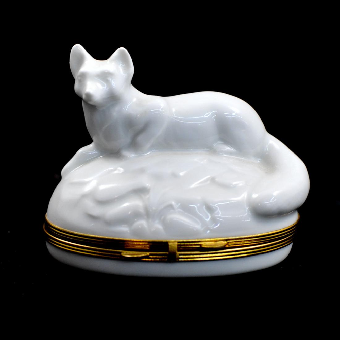 Limoges Porcelain "Fox" Trinket Box: DESCRIPTION: A Limoges porcelain trinket box features an all white motif of a fox laying over a naturalistic base, opens revealing Limoges markings. CIRCA: 20th Cent. ORIGIN: France DIMENSIONS: H: 2.7