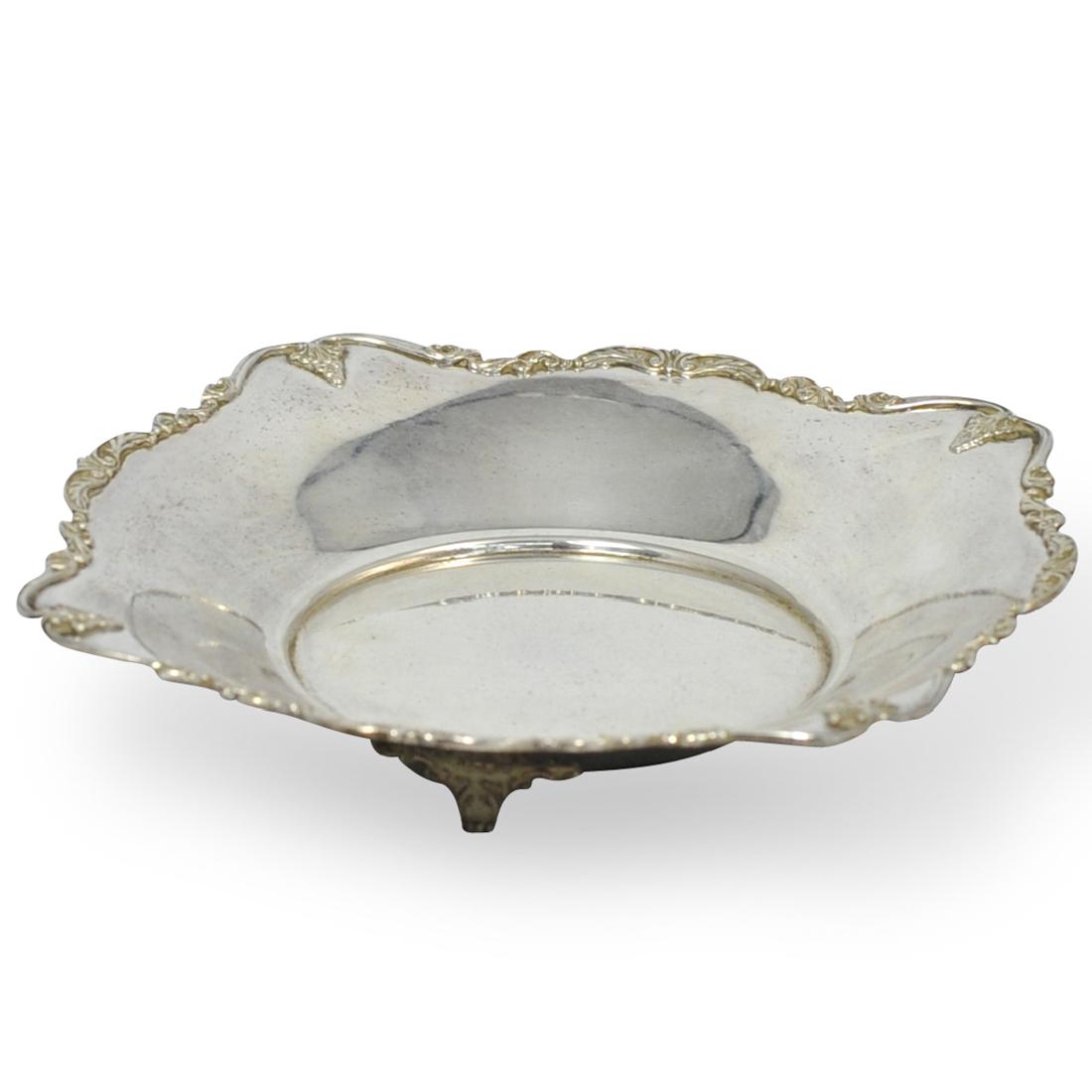 Sterling Silver Footed Bowl: DESCRIPTION: A Sterling silver footed bowl with repousse floral design on the rim on three scroll feet. No apparent markings. Weight: 262 grams. CIRCA: 20th Century ORIGIN: Continental DIMENSIONS: H.