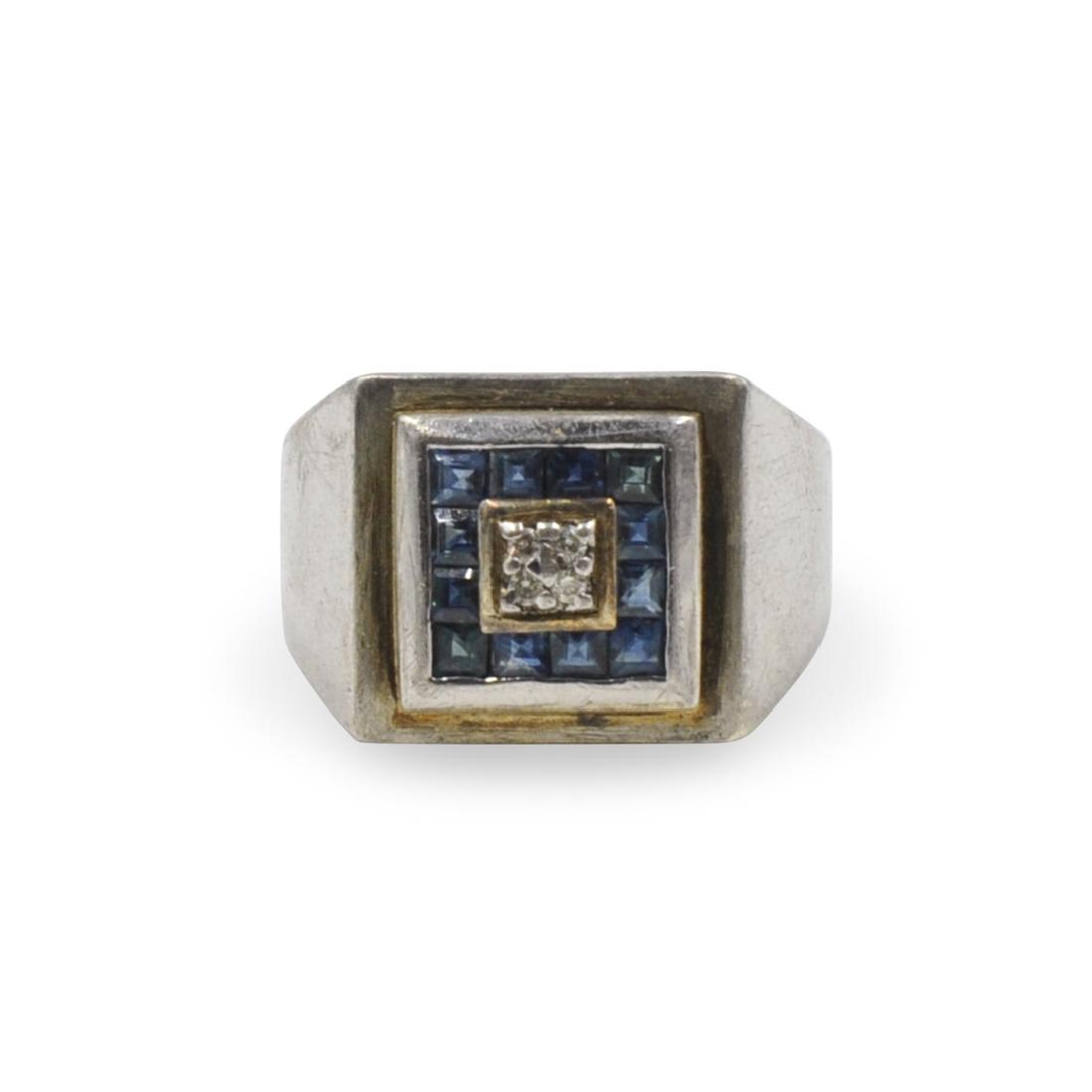 Sterling Silver and Sapphire Ring: DESCRIPTION: A Sterling silver and sapphire ring. Features 12 small center cut blue sapphire stones with pointer diamonds on center. Weight: 7.1 grams. Marked "925" "Stauer" CIRCA: 20th Century ORIGIN