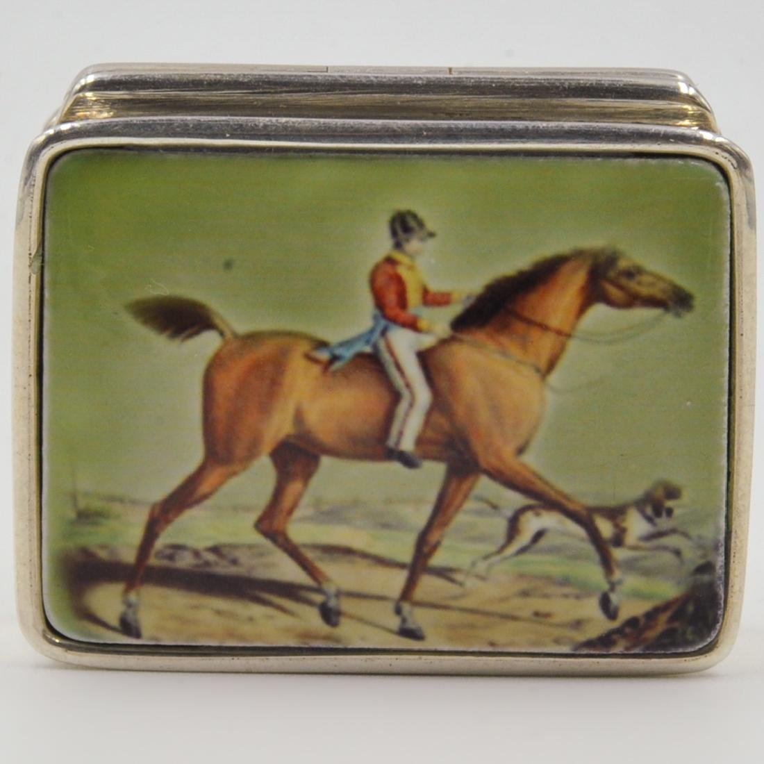Sterling Silver and Enamel Pill Box: DESCRIPTION: A Sterling silver and enamel pill box. Features a gentleman on horseback. Marked "Sterling". Weight: 19.8 grams CIRCA: 20th Century ORIGIN: Continental DIMENSIONS: L. 1 1/8" CONDITION: Gr