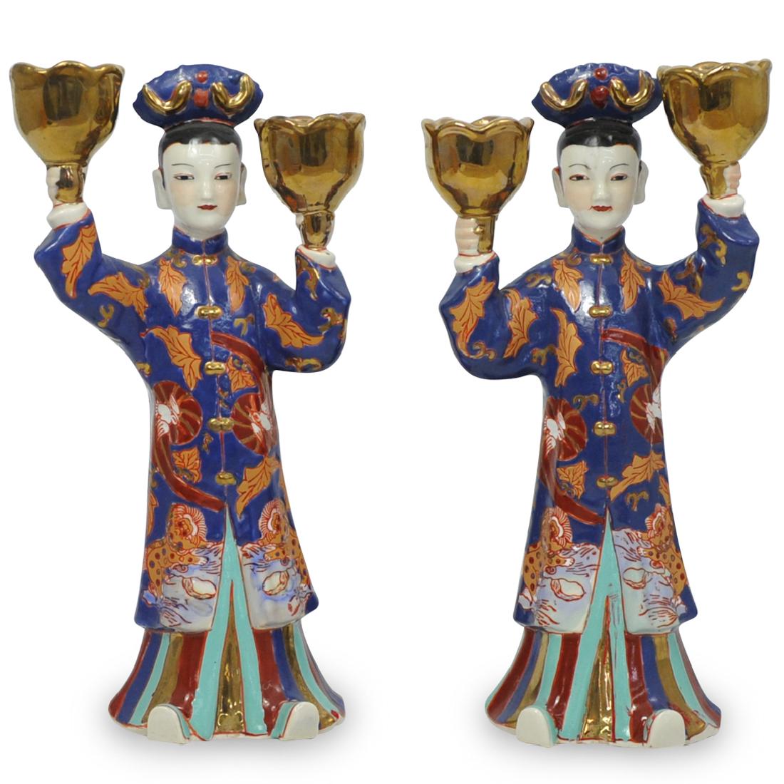 Pair of Chinese Figural Candelabras: DESCRIPTION: A Pair of Chinese porcelain figural candelabras. Depicts two Chinese deities dressed in elaborate robes, holding gilded floral form planters with candle sticks in place. No apparent marki