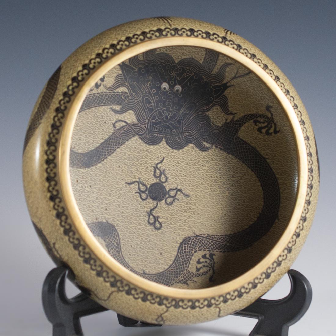 Signed Cloisonne Enameled Dragon Bowl: DESCRIPTION:Signed cloisonne dragon bowl featuring very intricate wired enameled dragons along the exterior of the bowl with a rich light brown base color. The interior features imperial five finger d